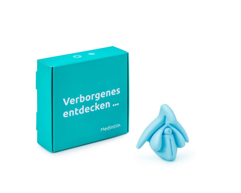 Clitoris Plus | 1:1-Modell in hellblau mit Verpackung